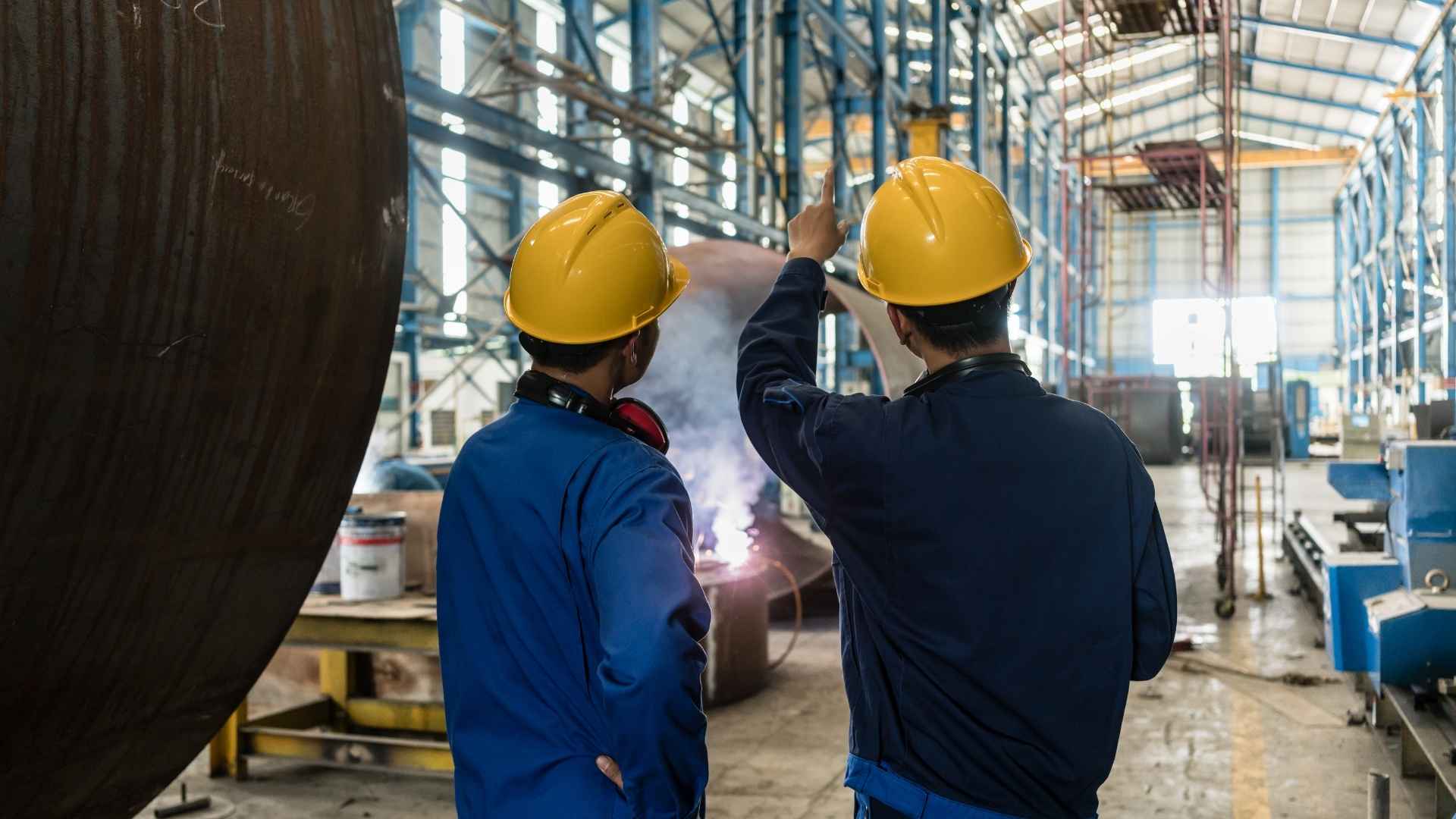 industrial workers supervising fabrication